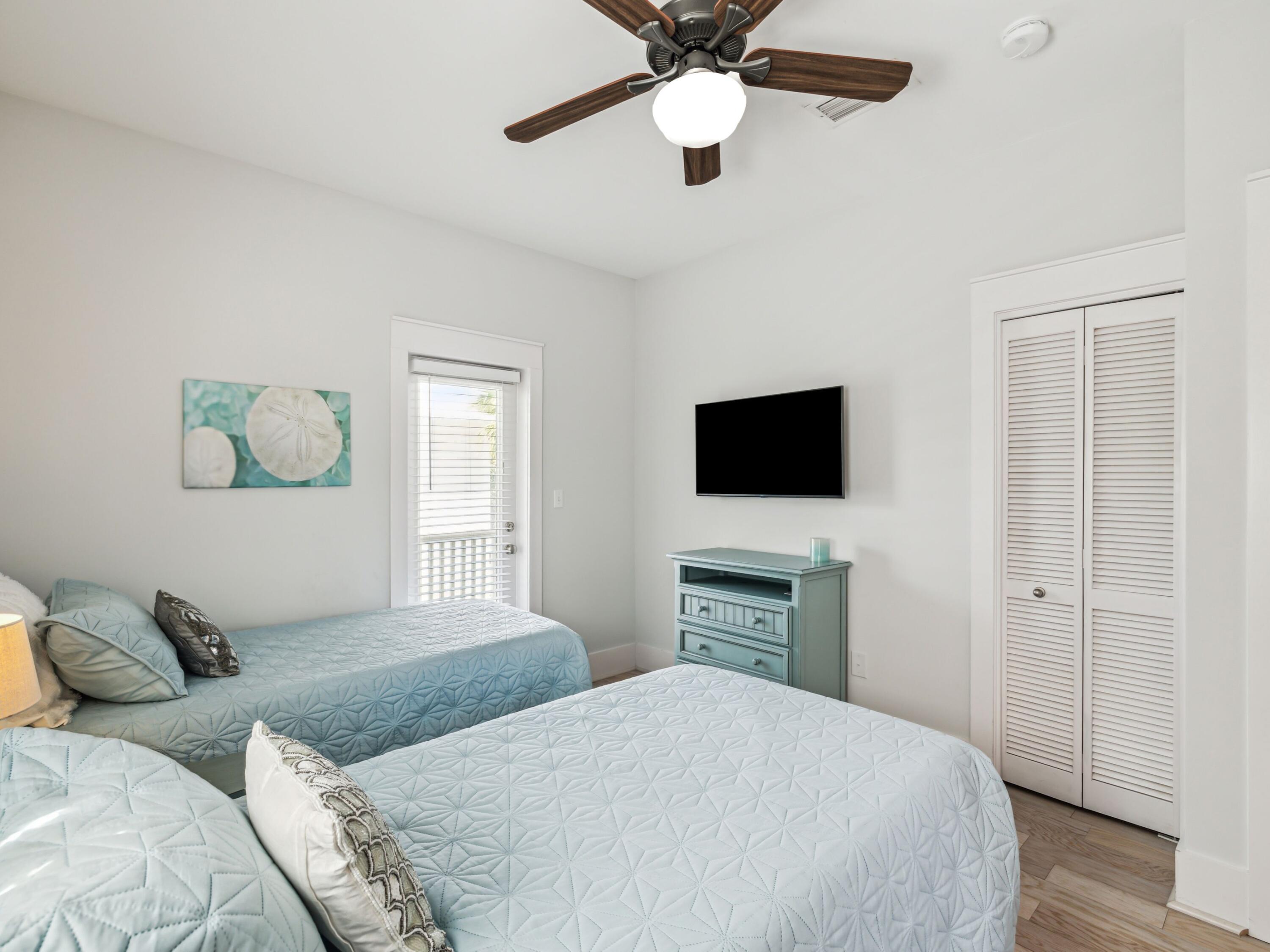 198 Somerset Bridge Road, Unit 103 Santa Rosa Beach, FL 32459 - Photo 27 of 39 a bedroom with a bed and a flat screen tv