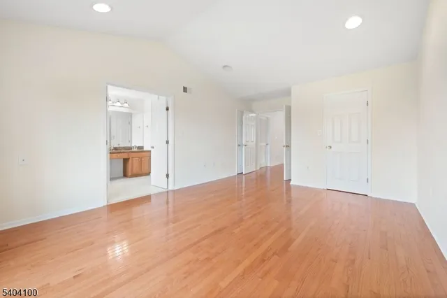 a spacious bedroom with a bed and a couch