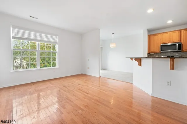 a view of empty room with wooden floor