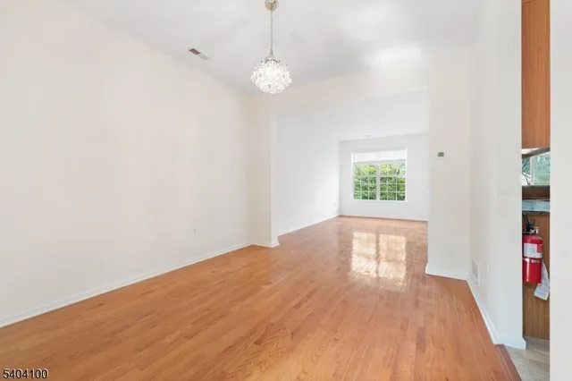 a dining room with furniture potted plants and wooden floor