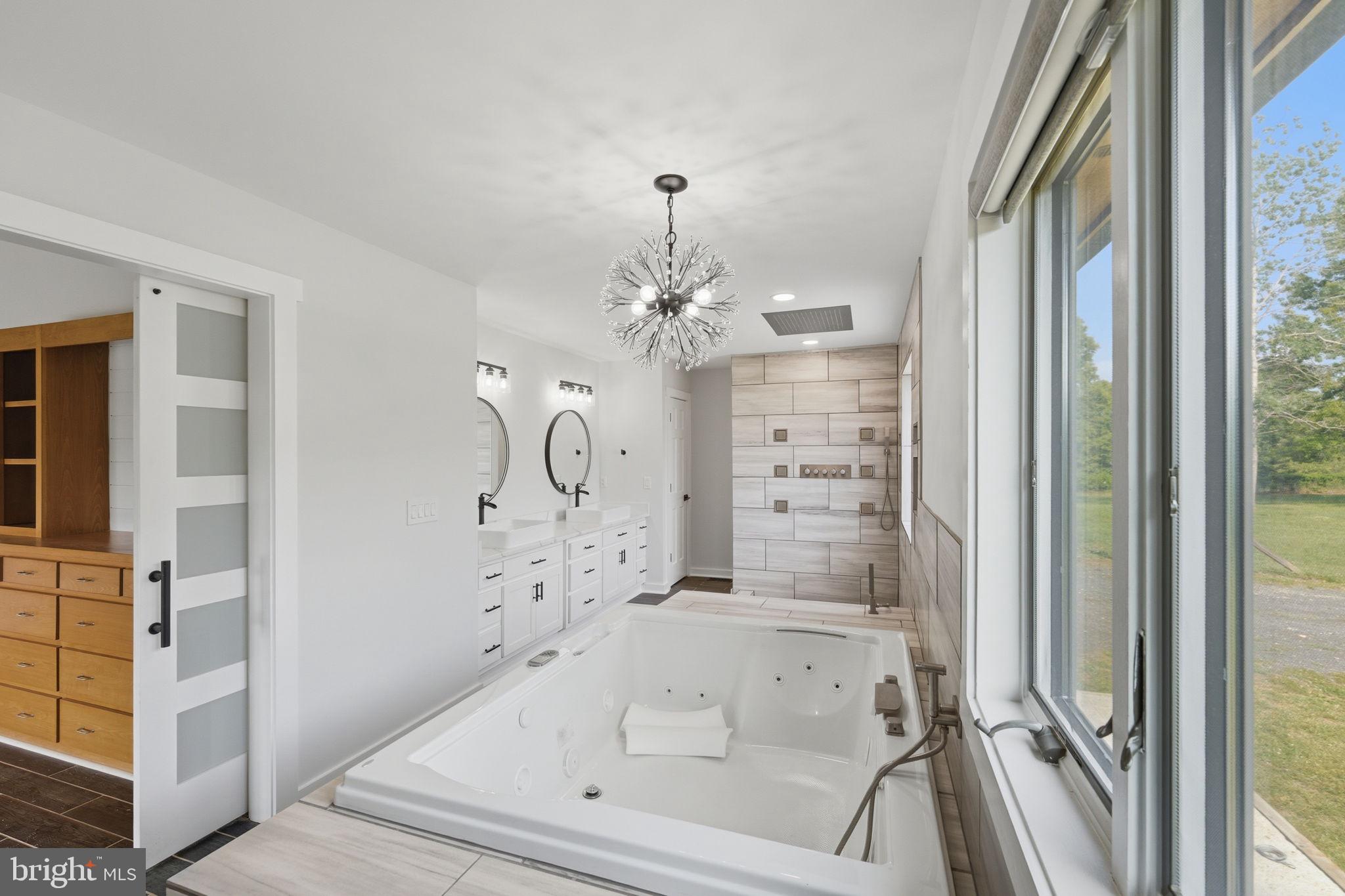 7522 Stubbs Bridge Road Spotsylvania, VA 22551 - Photo 22 of 60 a bathroom with a bathtub and a shower