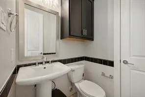 a bathroom with a sink a mirror and a toilet