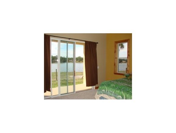 6411 Sorrel Drive, Unit STABLE Cocoa, FL 32926 - Photo 10 of 12 a picture of a living room with a floor to ceiling window and a yard