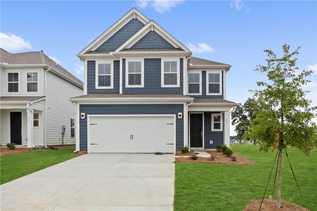 631 Sweetspire Trail, Unit 148 Seneca, SC 29678 - Photo 1 of 36 A newly constructed residence showcasing classic siding, an attached garage, and a welcoming front entrance.