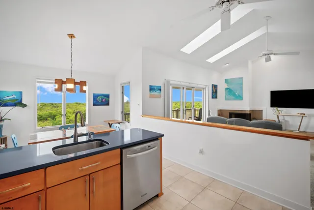 a kitchen with kitchen island granite countertop a sink and a stove