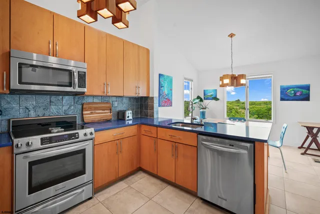 a kitchen with a sink stove and microwave