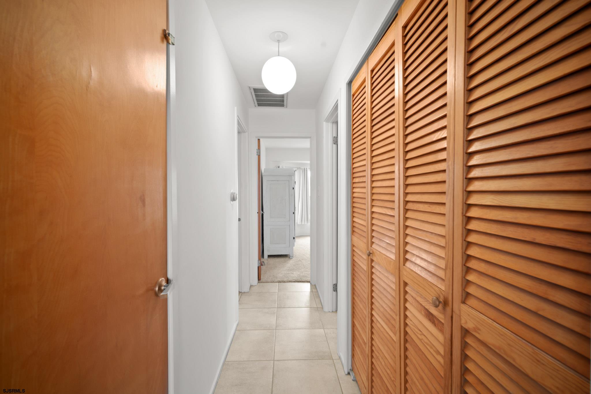45 Coquille, Unit 45 Brigantine, NJ 08203 - Photo 19 of 30 a view of a bathroom from a hallway