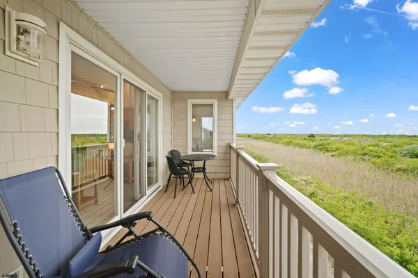 a view of a balcony with chair and table