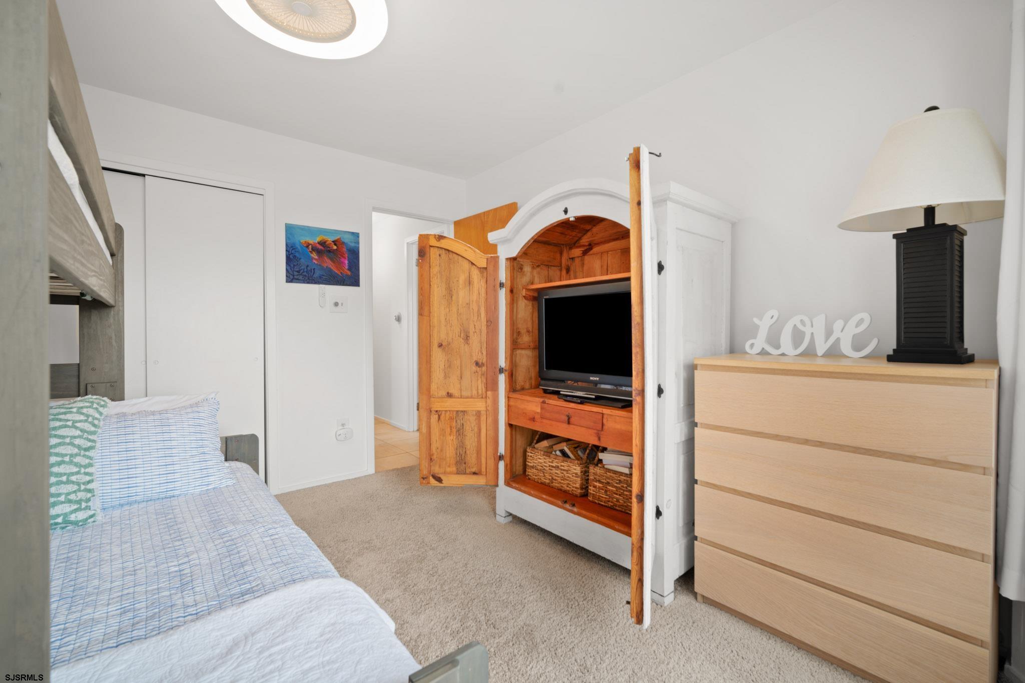 45 Coquille, Unit 45 Brigantine, NJ 08203 - Photo 29 of 30 a living room with furniture and a flat screen tv