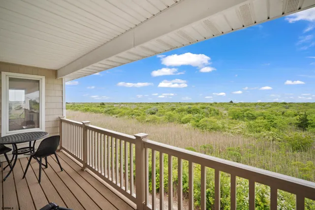 a view of roof deck with chair and wooden floor