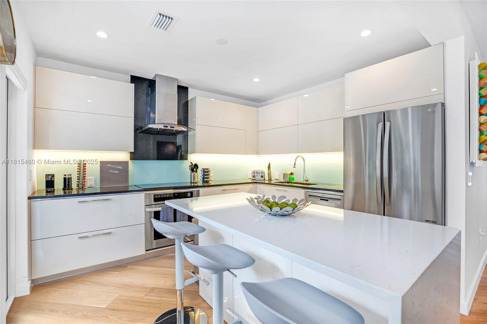 38 Southwest 25th Road Miami, FL 33129 - Photo 16 of 29 a kitchen with stainless steel appliances cabinets and wooden floor