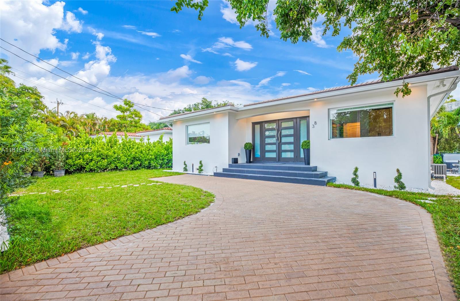 38 Southwest 25th Road Miami, FL 33129 - Photo 3 of 29 a front view of a house with a garden and yard