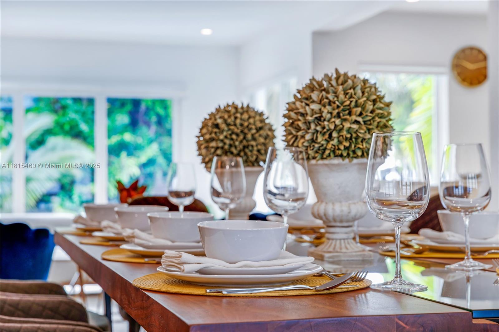 38 Southwest 25th Road Miami, FL 33129 - Photo 7 of 29 a view of a dining room with furniture a chandelier and large windows