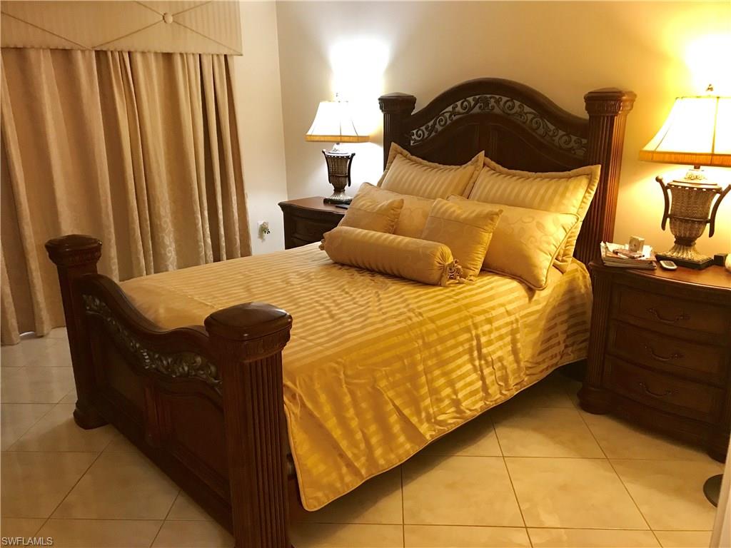 4256 31st Place Southwest Naples, FL 34116 - Photo 11 of 20 a bedroom with a bed and dresser