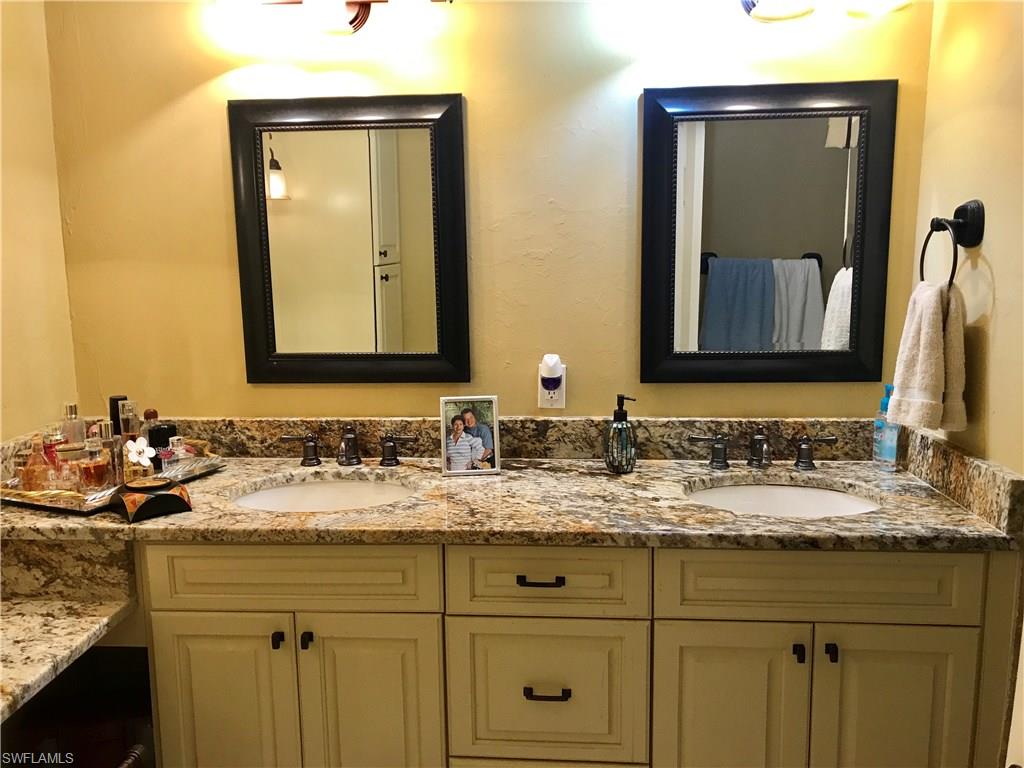 4256 31st Place Southwest Naples, FL 34116 - Photo 12 of 20 a bathroom with a sink and a mirror