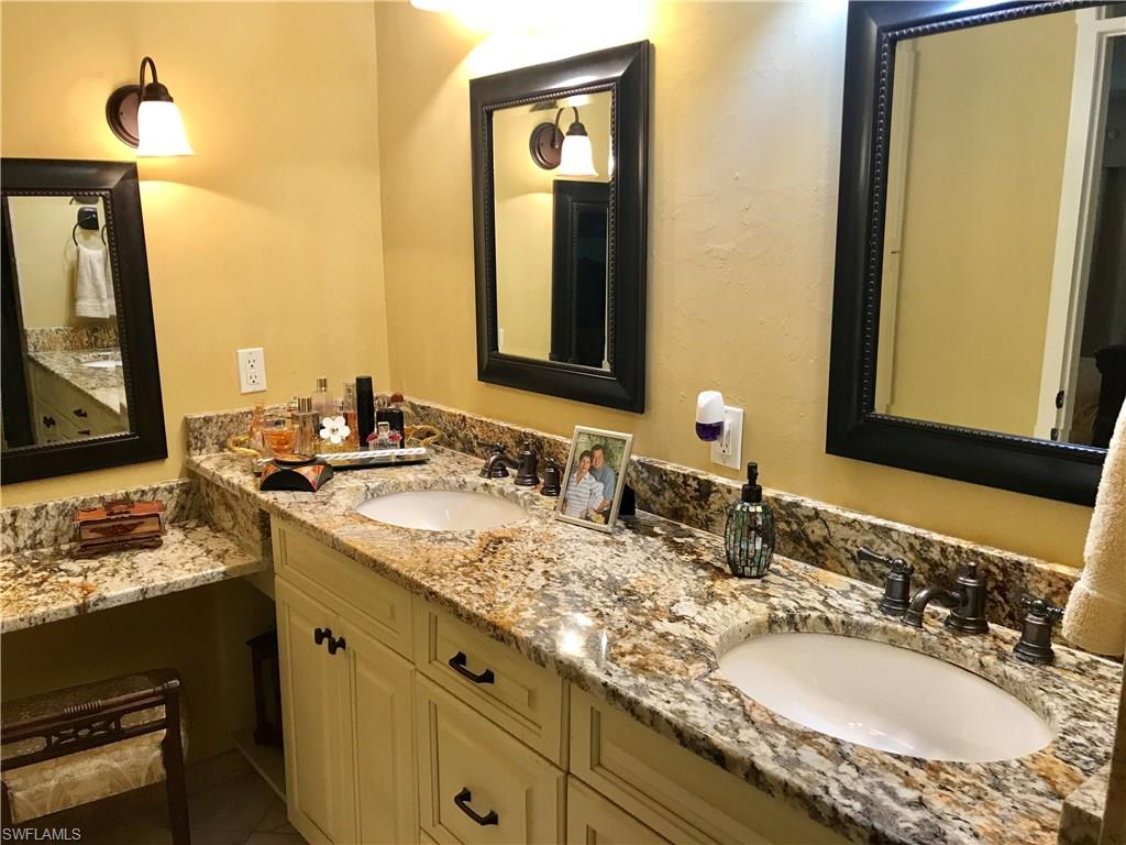 4256 31st Place Southwest Naples, FL 34116 - Photo 13 of 20 a bathroom with a granite countertop sink and a mirror