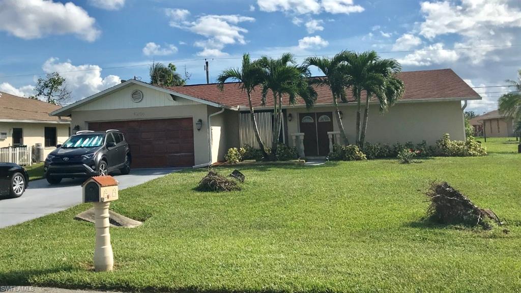 4256 31st Place Southwest Naples, FL 34116 - Photo 2 of 20 a front view of a house with garden