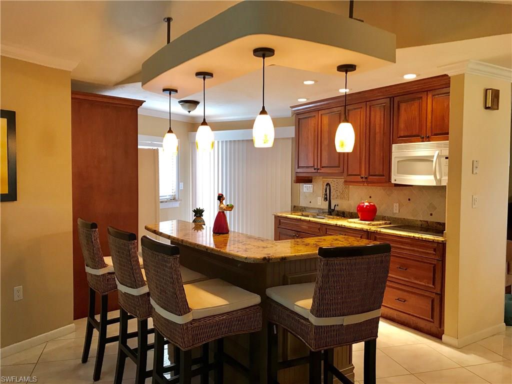 4256 31st Place Southwest Naples, FL 34116 - Photo 4 of 20 a dining room with a table and chairs