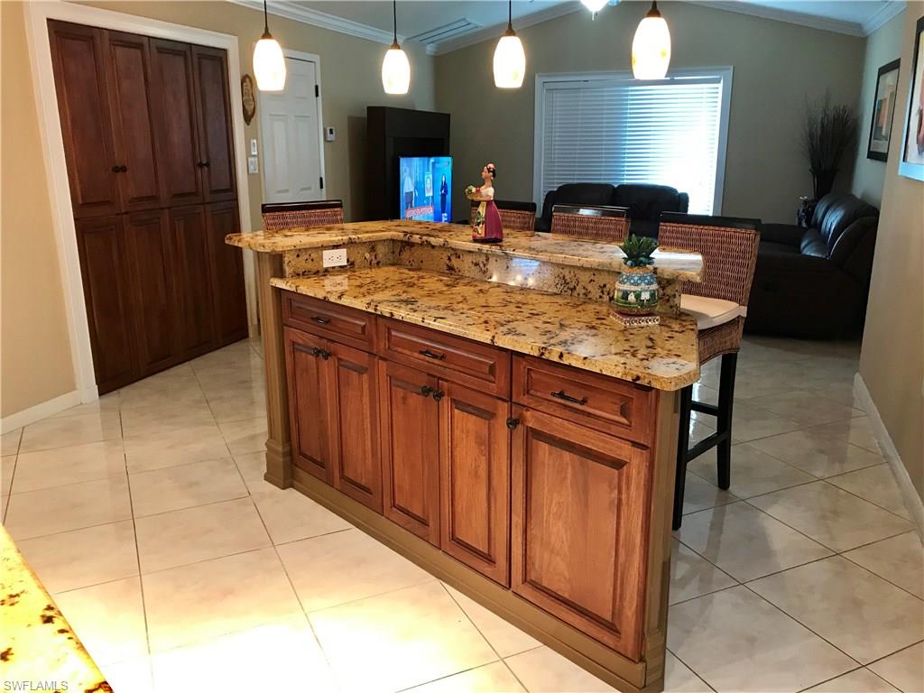 4256 31st Place Southwest Naples, FL 34116 - Photo 7 of 20 a bathroom with a granite countertop sink and a mirror