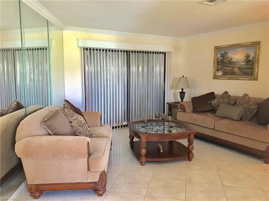 4256 31st Place Southwest Naples, FL 34116 - Photo 8 of 20 a living room with furniture and a window