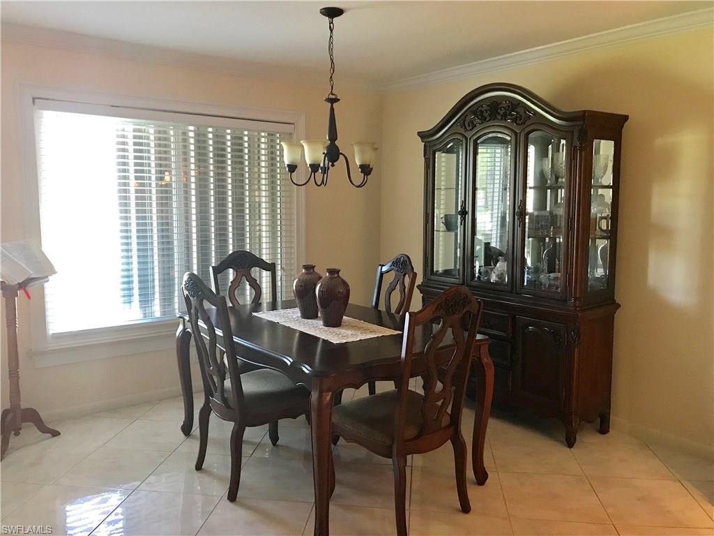 4256 31st Place Southwest Naples, FL 34116 - Photo 9 of 20 a view of a dining room with furniture and window