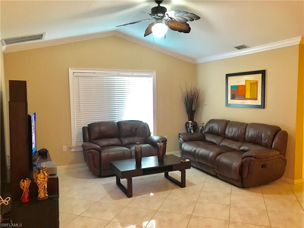 4256 31st Place Southwest Naples, FL 34116 - Photo 10 of 20 a living room with furniture and a flat screen tv