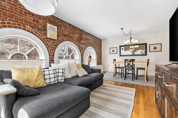 a living room with furniture and a chandelier