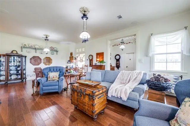 a living room with furniture and a chandelier