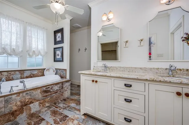 a spacious bathroom with a granite countertop sink mirror and