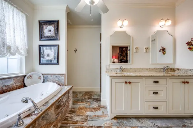 a spacious bathroom with a granite countertop sink and a mirror