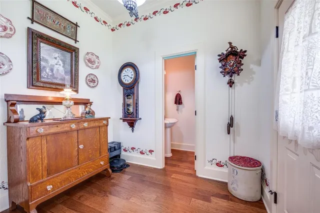 a hallway with painting on the wall and a window
