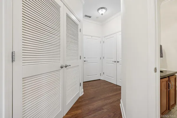 a view of a hallway with wooden floor