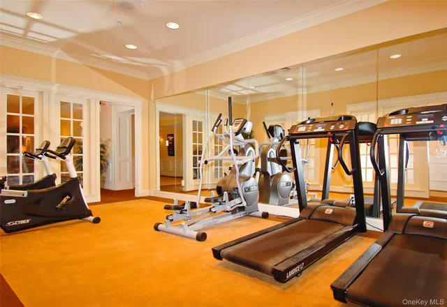 a room with gym equipment and large mirror