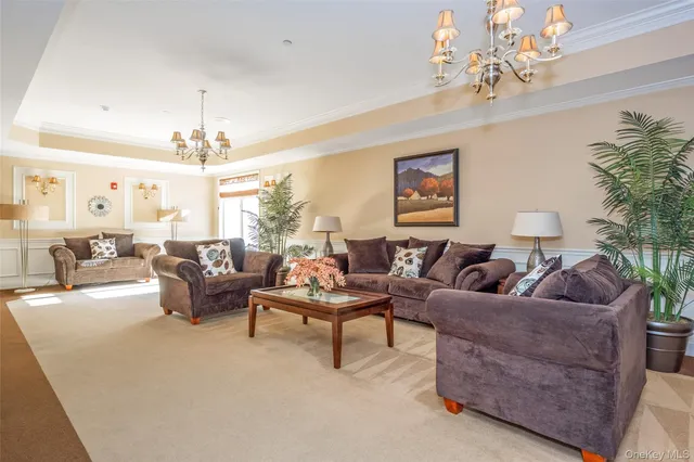 a living room with furniture and a chandelier