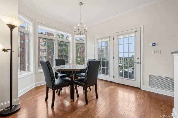 a view of a dining room with furniture window and wooden floor