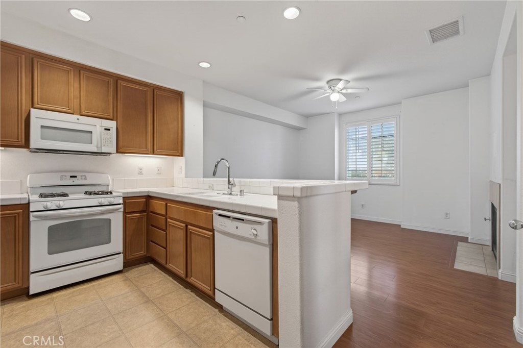 3924 Polk Street, Unit E Riverside, CA 92505 - Photo 5 of 22 a kitchen with a sink stove and cabinets