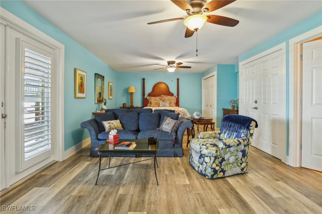 8335 Main Street Bokeelia, FL 33922 - Photo 41 of 47 a living room with furniture a chandelier and a rug