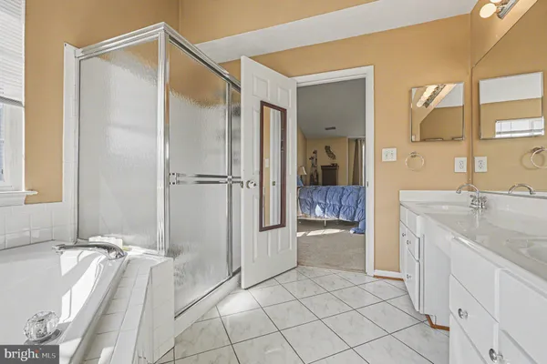 a bedroom with a bed and ceiling fan