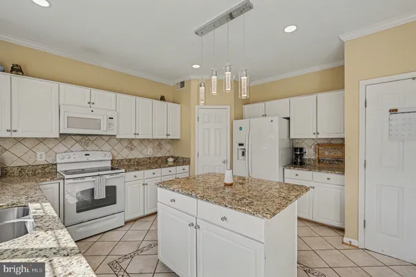 a kitchen with a sink stove and refrigerator