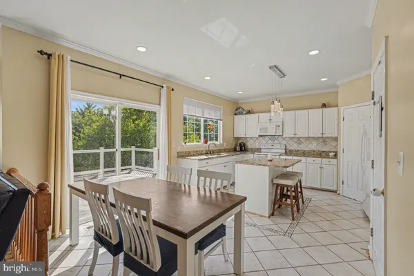a kitchen with a table chairs stove and cabinets