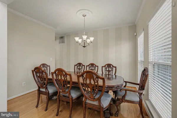 a view of a dining room with furniture wooden floor and a chandelier