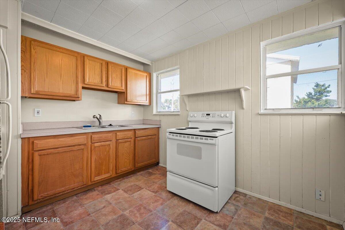 725 5th Street North Jacksonville, FL 32250 - Photo 14 of 18 a kitchen with granite countertop a sink stainless steel appliances and cabinets