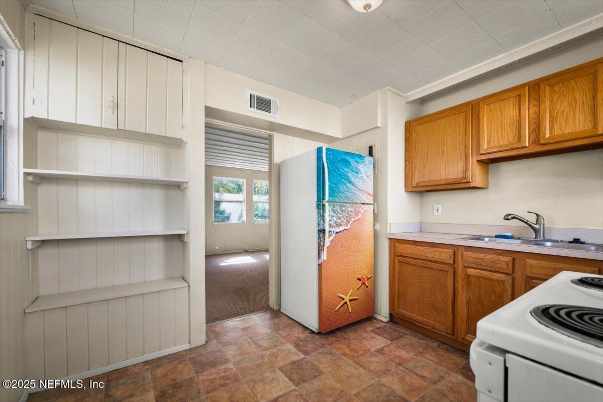 725 5th Street North Jacksonville, FL 32250 - Photo 15 of 18 a utility room with cabinets washer and dryer