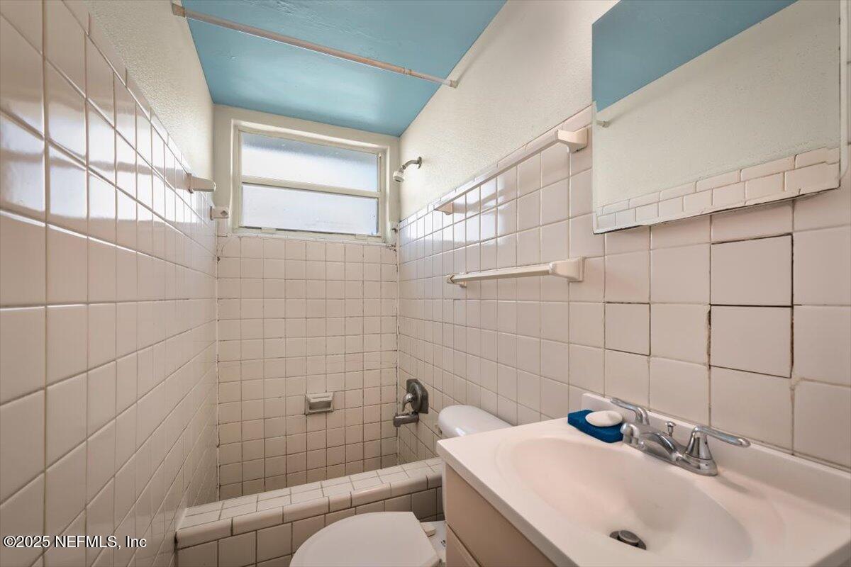 725 5th Street North Jacksonville, FL 32250 - Photo 18 of 18 a bathroom with a sink a toilet and shower