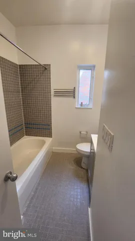 a bathroom with a toilet a sink and bathtub