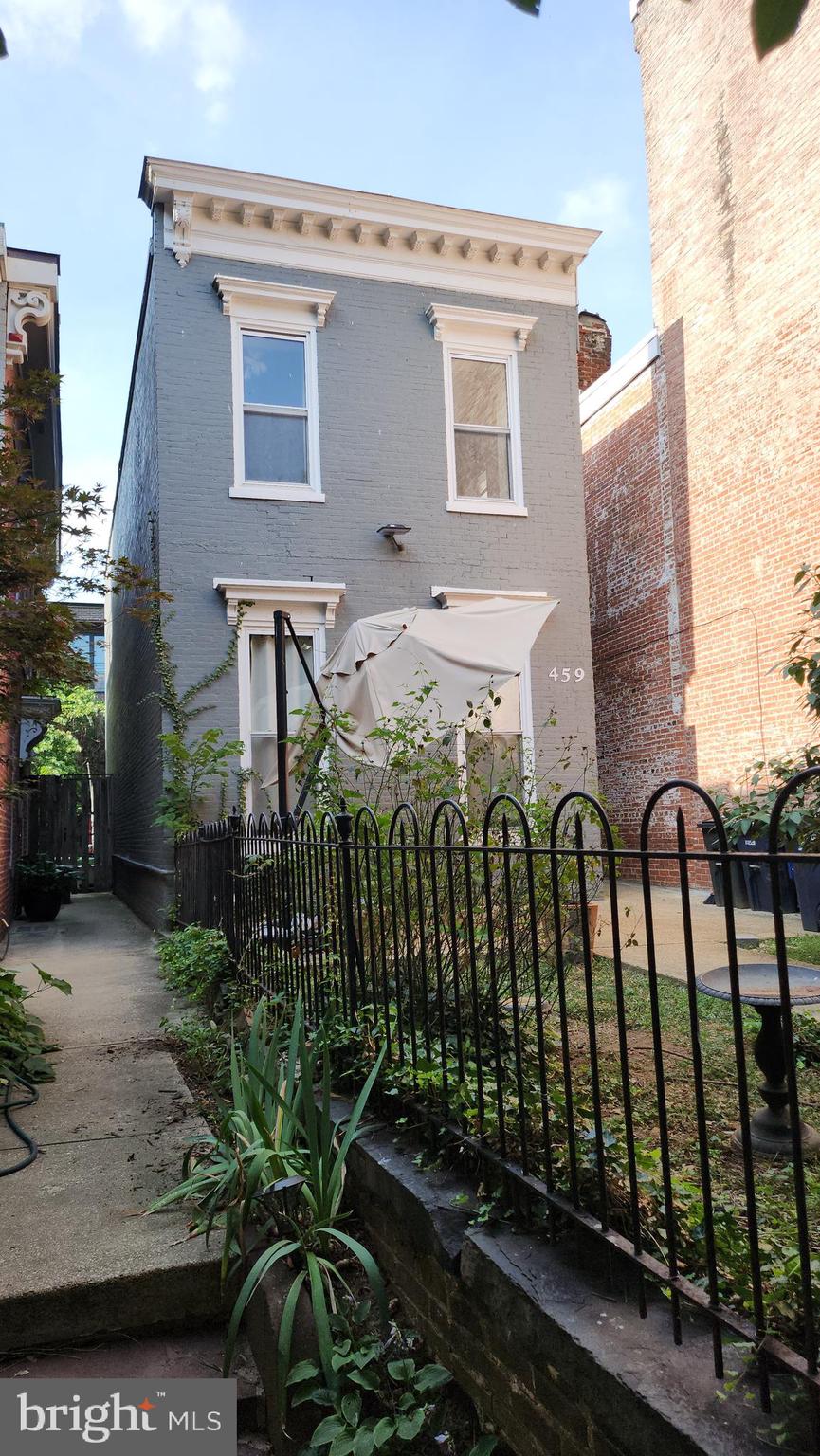 459 M Street Northwest, Unit C Washington, DC 20001 - Photo 6 of 8 a view of a house with a cars park side of road