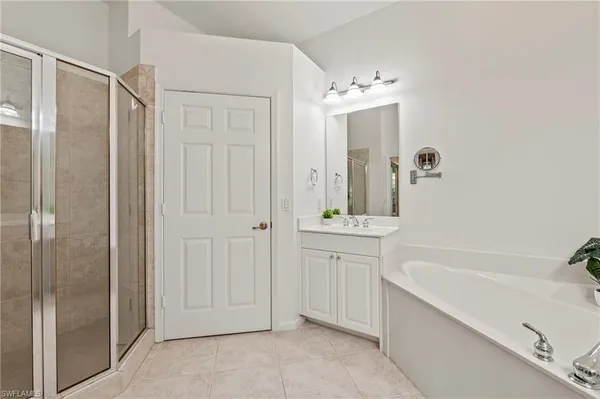 a spacious bathroom with a tub shower and sink