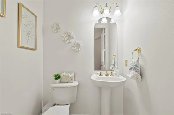 a bathroom with a sink mirror and toilet