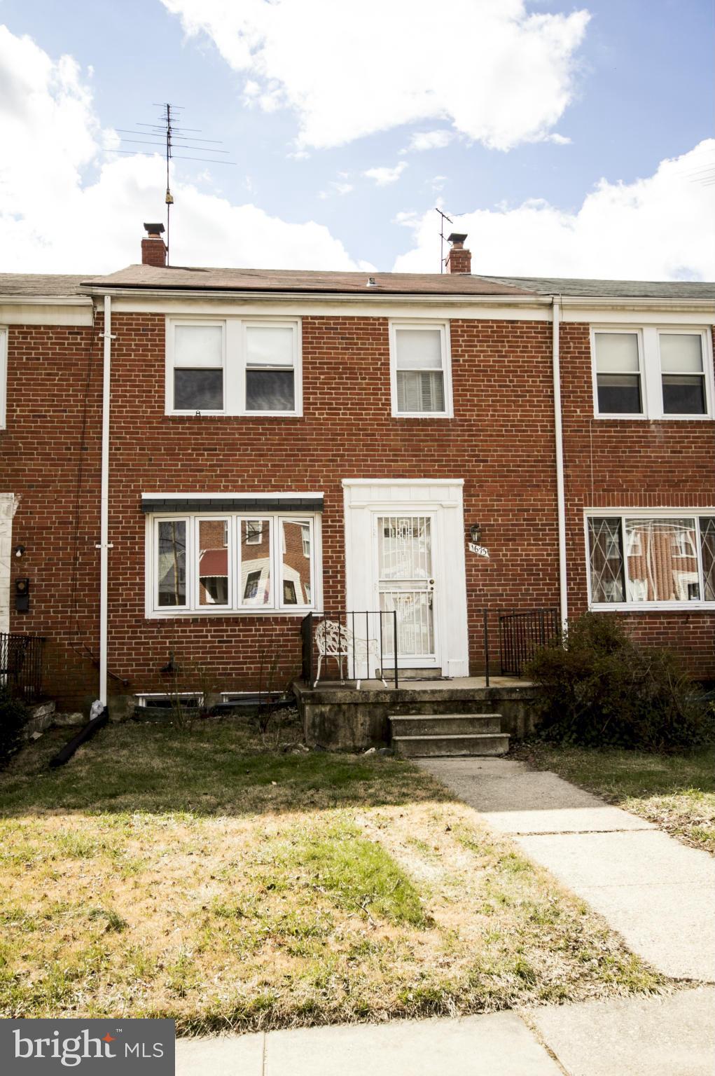 1673 Northbourne Road Baltimore, MD 21239 - Photo 1 of 21 a front view of a house with a yard