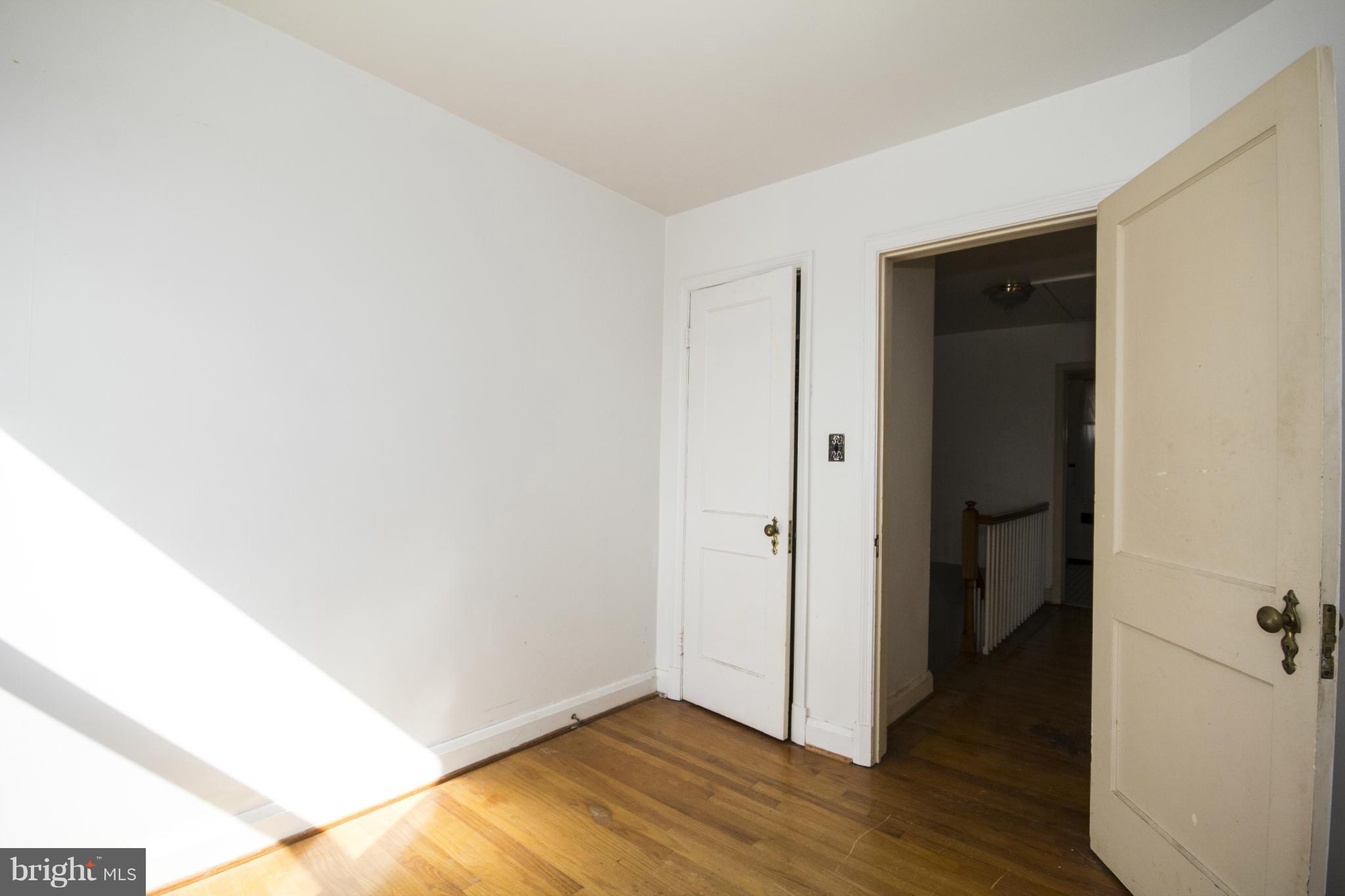 1673 Northbourne Road Baltimore, MD 21239 - Photo 17 of 21 a view of an empty room with wooden floor